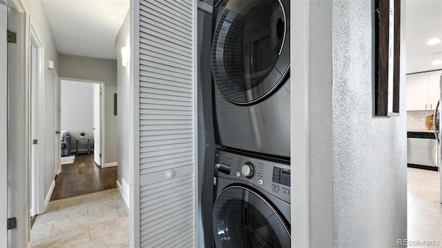 2829 Illinois Ave, Colorado Springs, CO 80907 - washroom featuring stacked washer / drying machine and light tile patterned floors
