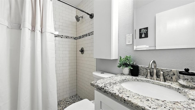 2829 Illinois Ave, Colorado Springs, CO 80907 - bathroom with vanity, a tile shower, and a textured wall
