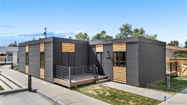 1959 Blackhawk St, Aurora, CO 80011 - view of front facade with a wooden deck
