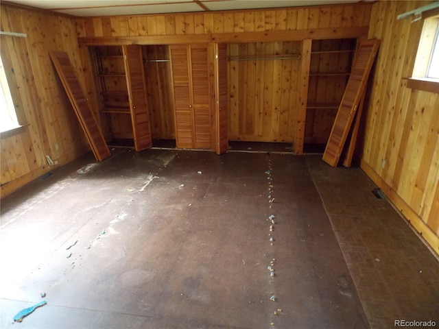 222 S Fairview St, Woodland Park, CO 80863 - unfurnished bedroom featuring multiple windows and wooden walls