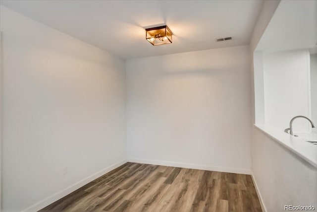 empty room with hardwood / wood-style floors