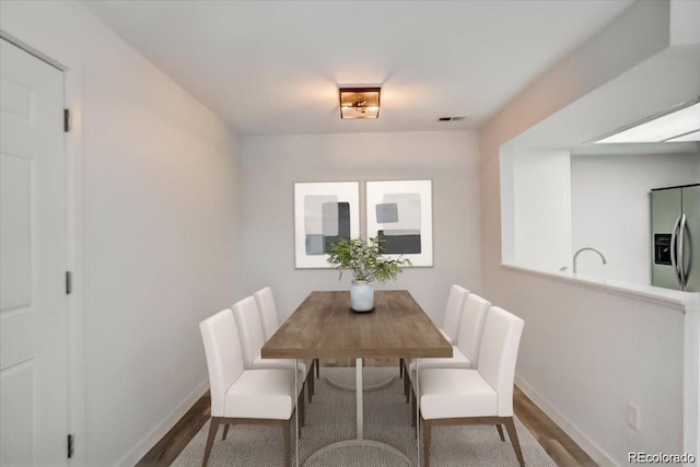 7870 W 87th Dr Unit J, Arvada, CO 80005 - dining area with baseboards, visible vents, and wood finished floors