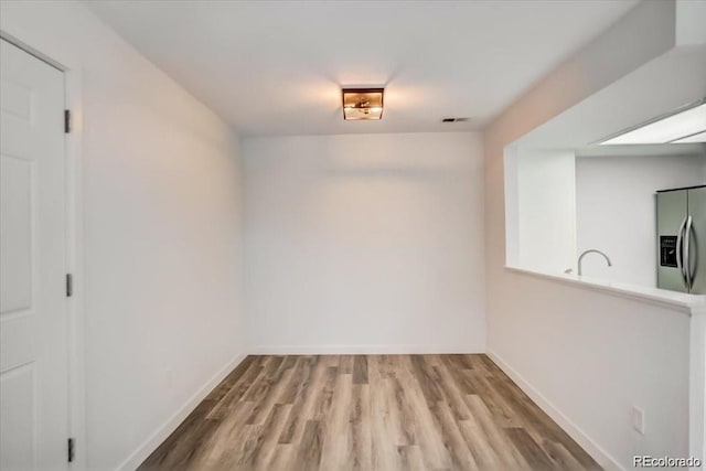 7870 W 87th Dr Unit J, Arvada, CO 80005 - unfurnished dining area featuring baseboards, visible vents, and wood finished floors