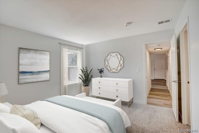 7870 W 87th Dr Unit J, Arvada, CO 80005 - bedroom with light carpet, baseboards, and visible vents