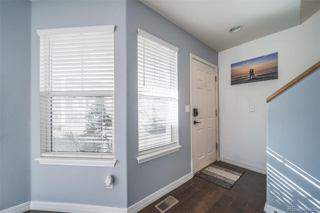 entrance foyer featuring dark wood finished floors, baseboards, and visible vents