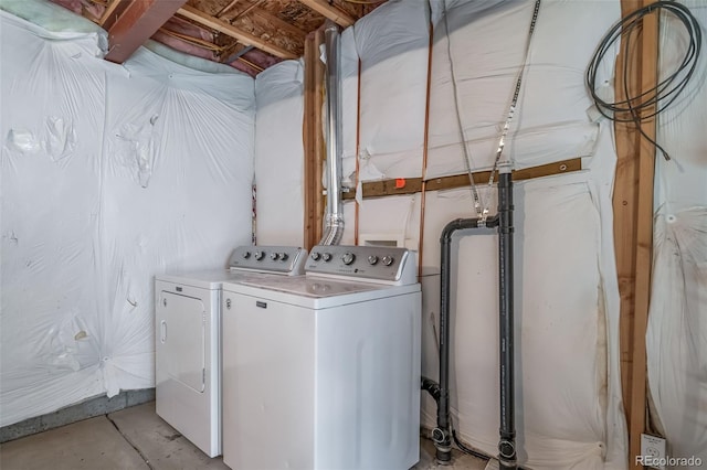 clothes washing area featuring washer and clothes dryer and laundry area