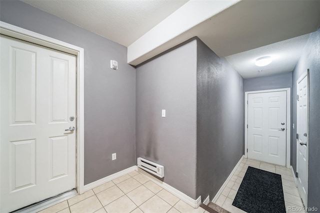 interior space with light tile patterned flooring and baseboards