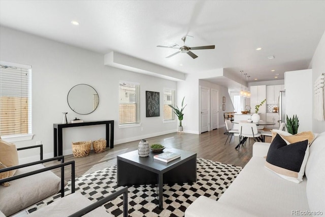 living room with recessed lighting, baseboards, and wood finished floors