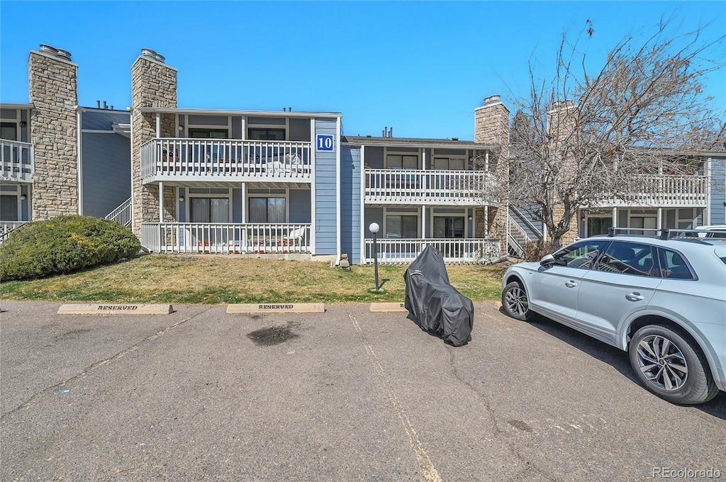 8335 Fairmount Dr Unit 102, Denver, CO 80247 - view of building exterior with uncovered parking
