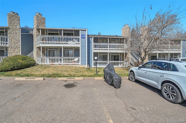 view of building exterior with uncovered parking