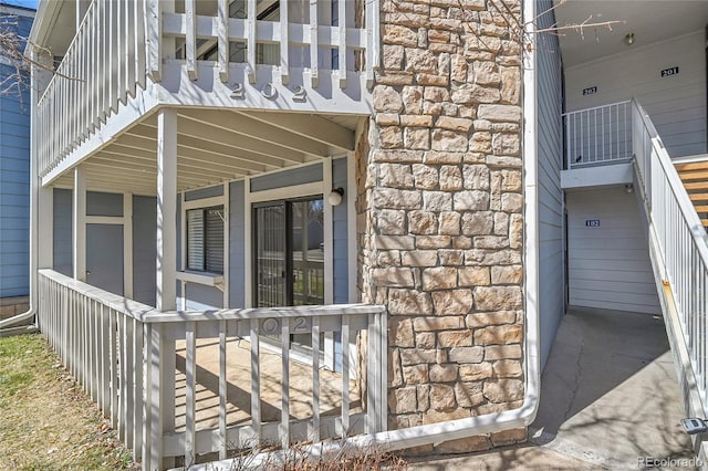 entrance to property featuring stone siding