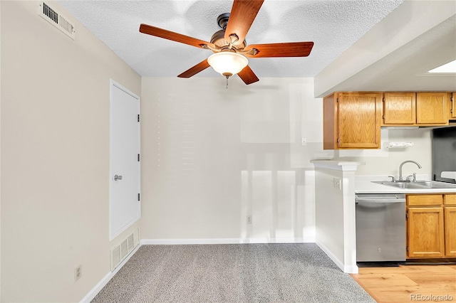 kitchen featuring visible vents, dishwasher, a ceiling fan, and a sink