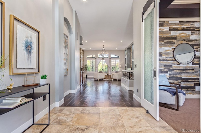 entrance foyer featuring a barn door and an inviting chandelier