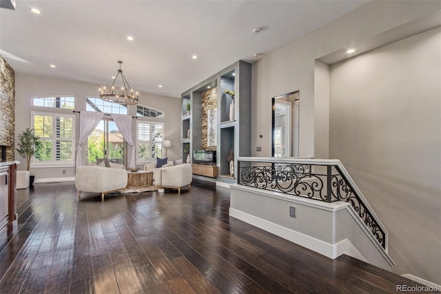 interior space featuring built in features, dark wood-type flooring, and a notable chandelier