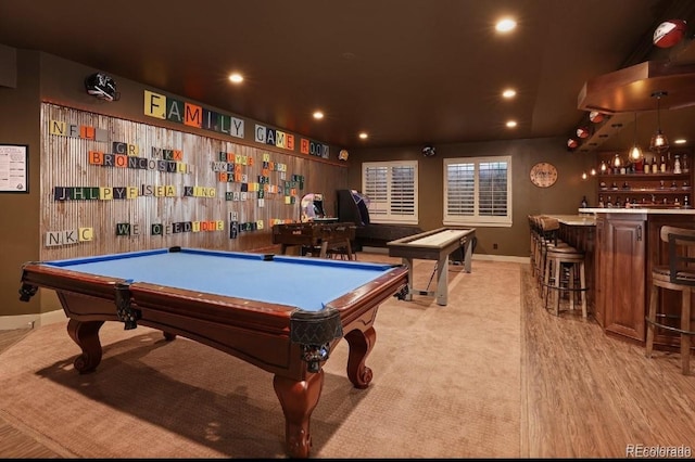 game room featuring light hardwood / wood-style floors, indoor bar, and pool table