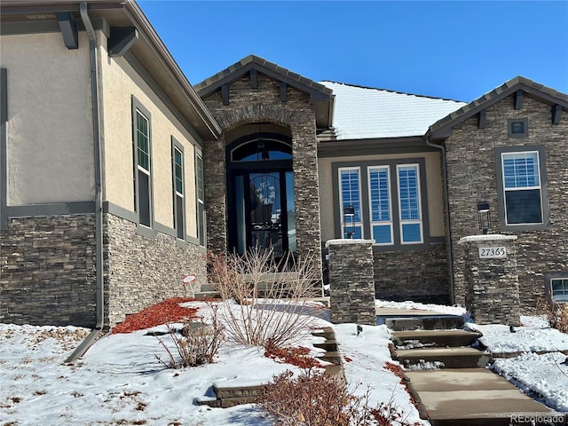 view of snow covered property entrance