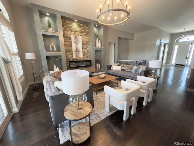 living room with dark hardwood / wood-style flooring, a chandelier, and built in features