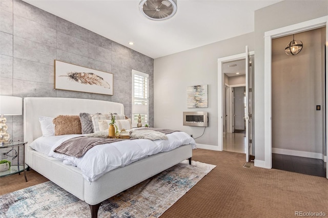 bedroom with heating unit and carpet floors