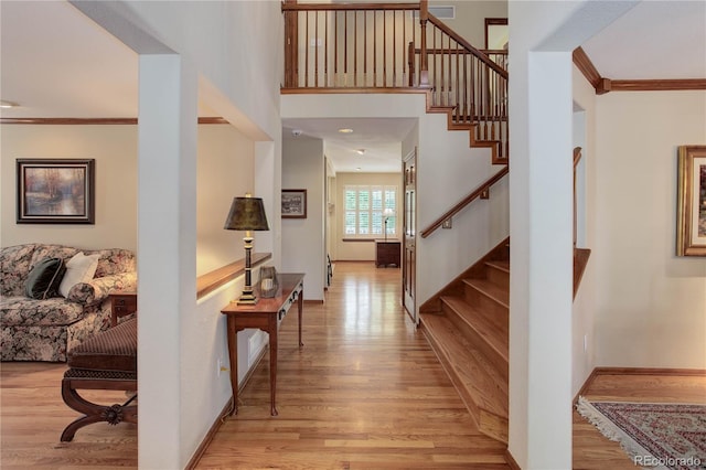 10032 Astoria Ct, Lone Tree, CO 80124 - entrance foyer with light wood-style flooring, stairway, and ornamental molding