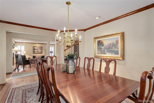 10032 Astoria Ct, Lone Tree, CO 80124 - dining area featuring a chandelier, wood finished floors, and ornamental molding