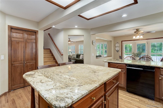 10032 Astoria Ct, Lone Tree, CO 80124 - kitchen featuring black dishwasher, a ceiling fan, a center island, light wood-style flooring, and recessed lighting