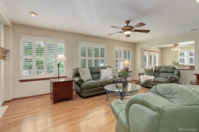 10032 Astoria Ct, Lone Tree, CO 80124 - living room featuring a ceiling fan, healthy amount of natural light, and light wood-style flooring