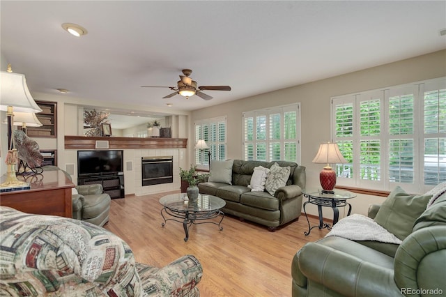10032 Astoria Ct, Lone Tree, CO 80124 - living area featuring ceiling fan, light wood-type flooring, and a tile fireplace