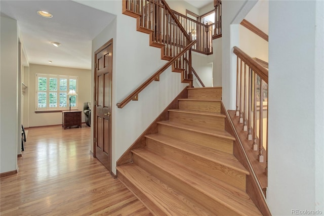 10032 Astoria Ct, Lone Tree, CO 80124 - staircase with wood finished floors and recessed lighting