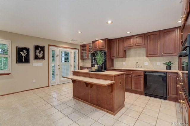 10032 Astoria Ct, Lone Tree, CO 80124 - kitchen featuring black dishwasher, light countertops, light tile patterned floors, plenty of natural light, and recessed lighting