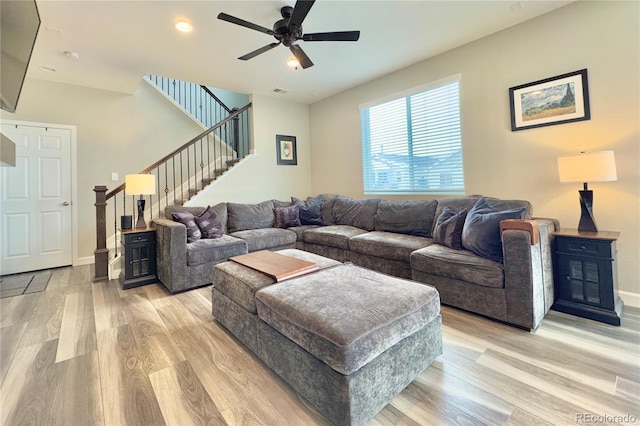 living room with ceiling fan and light hardwood / wood-style flooring