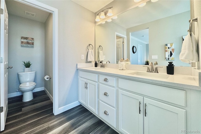 bathroom featuring vanity, wood-type flooring, and toilet