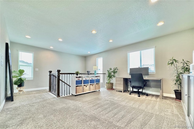 carpeted home office with a textured ceiling