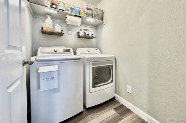 laundry area with independent washer and dryer and wood-type flooring