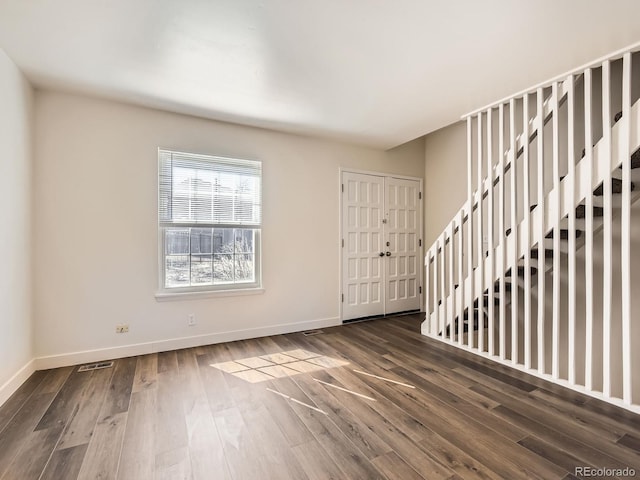 entryway with wood finished floors, visible vents, and baseboards