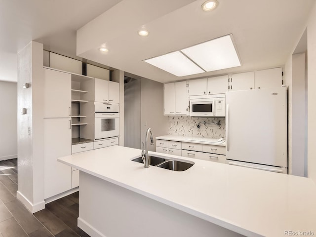 kitchen featuring white appliances, a sink, white cabinetry, open shelves, and tasteful backsplash