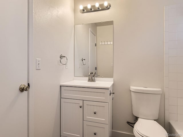 full bathroom with toilet and vanity