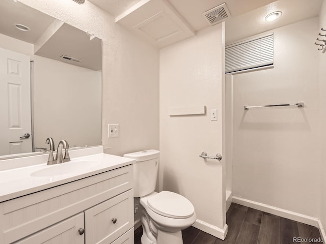 bathroom featuring visible vents, vanity, toilet, and wood finished floors