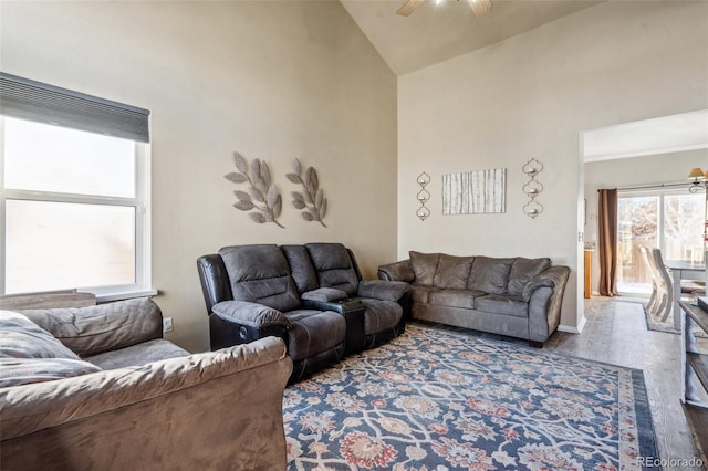 living room featuring ceiling fan, high vaulted ceiling, and hardwood / wood-style flooring