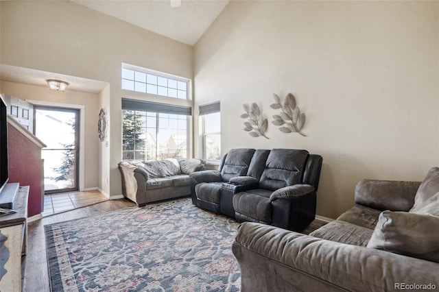 living room with high vaulted ceiling and hardwood / wood-style flooring