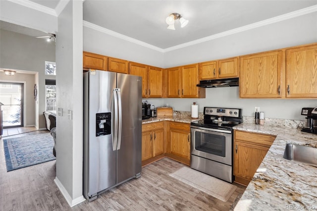 kitchen featuring light stone countertops, light wood-type flooring, appliances with stainless steel finishes, and crown molding