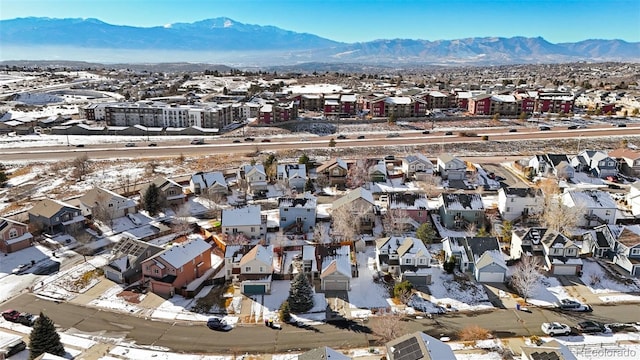 snowy aerial view with a mountain view