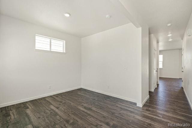 unfurnished room with dark hardwood / wood-style floors