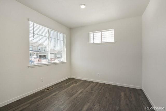 spare room with dark hardwood / wood-style floors