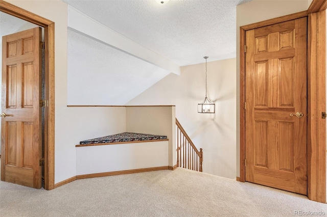 2650 S Vaughn Way Unit B, Aurora, CO 80014 - hallway featuring carpet floors, an upstairs landing, baseboards, and a textured ceiling