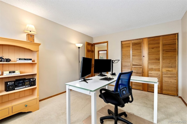2650 S Vaughn Way Unit B, Aurora, CO 80014 - office area featuring light carpet, baseboards, and a textured ceiling