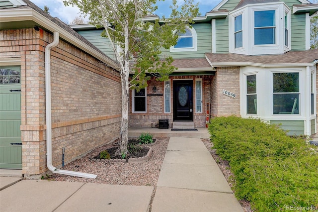 10059 Granite Hill Dr, Parker, CO 80134 - entrance to property featuring roof with shingles and brick siding