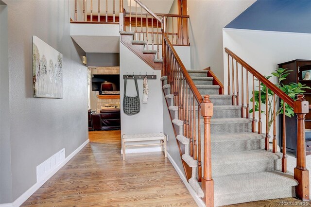 10059 Granite Hill Dr, Parker, CO 80134 - stairway with visible vents, wood finished floors, baseboards, and a high ceiling