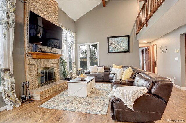 10059 Granite Hill Dr, Parker, CO 80134 - living area with light wood finished floors, a brick fireplace, baseboards, and high vaulted ceiling