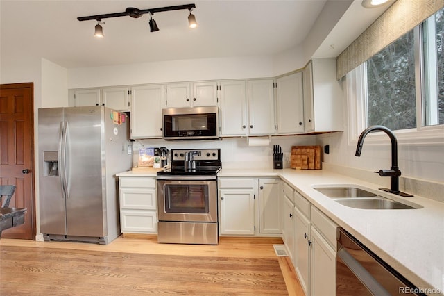 10059 Granite Hill Dr, Parker, CO 80134 - kitchen featuring white cabinetry, light countertops, stainless steel appliances, and a sink