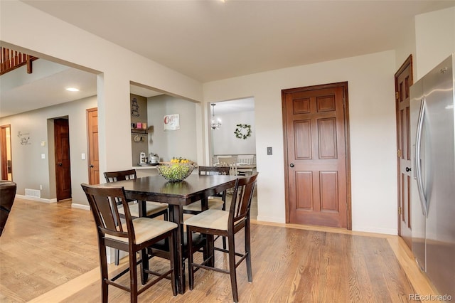 10059 Granite Hill Dr, Parker, CO 80134 - dining area featuring baseboards, light wood-style flooring, and visible vents
